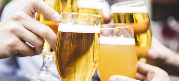 Five beer glasses touching during a toast
