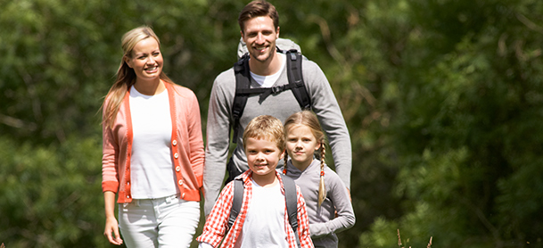 A family with two young children go hiking