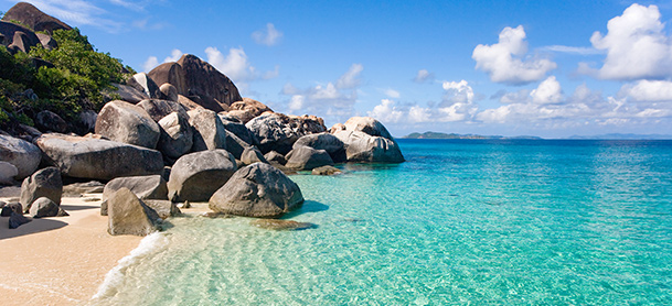 Large rocks near clear blue ocean water