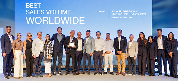 MarineMax and Azimut Yachts team members posing onstage with an award in front of a “Best Sales Volume Worldwide” display.