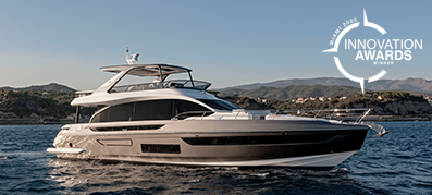 The Azimut Fly 72 yacht glides on calm ocean waters against a backdrop of mountains.